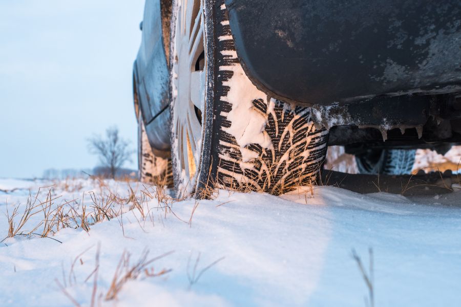 Car winter tires on snowy road