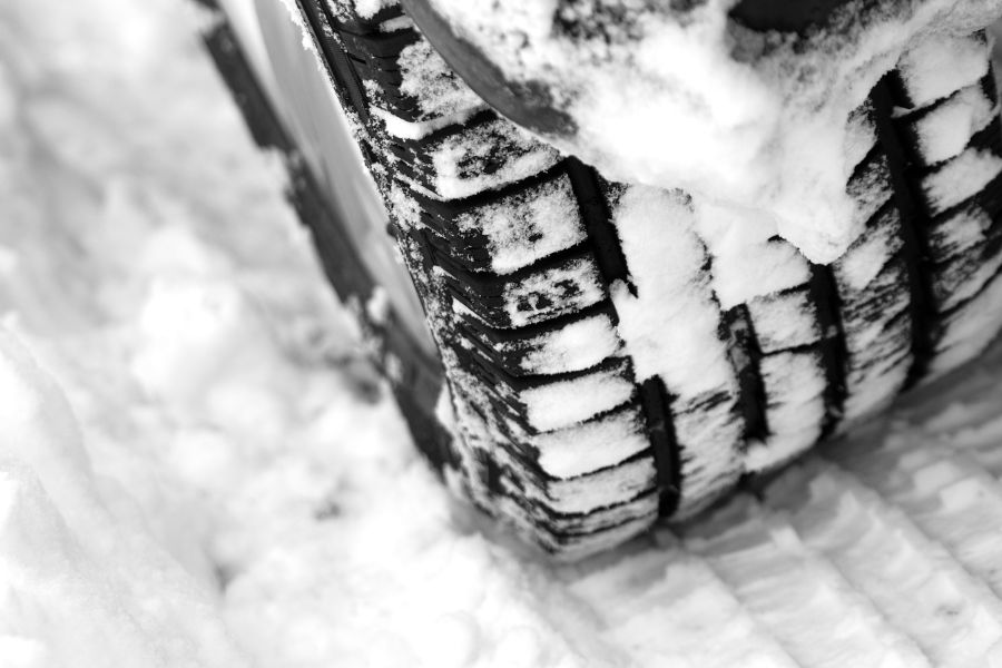 Close up view of a winter tire in snow